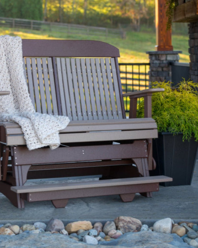 4 foot classic balcony glider weatherwood and chestnut brown on patio with fireplace