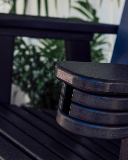 LuxCraft slide out cup holder featured in the closed position on a black Adirondack Glider chair.