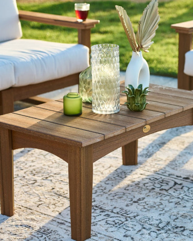 LuxCraft Island Coffee Table featured in Antique Mahogany alongside the Lanai Deep Seating with Canvas Cushions.