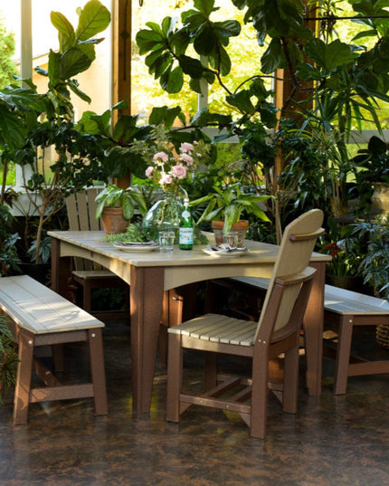 LuxCraft Island Dining Table 44 x 72 rectangle featured in weatherwood and chestnut brown with Adirondack side chair and 72" café benches.