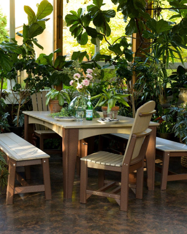 LuxCraft Island Dining Table 44 x 72 rectangle featured in weatherwood and chestnut brown with Adirondack side chair and 72" café benches.