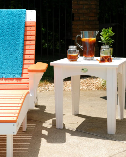 LuxCraft Island End Table featured in white alongside LuxCraft Lounge Chair featured ini tangerine and white.