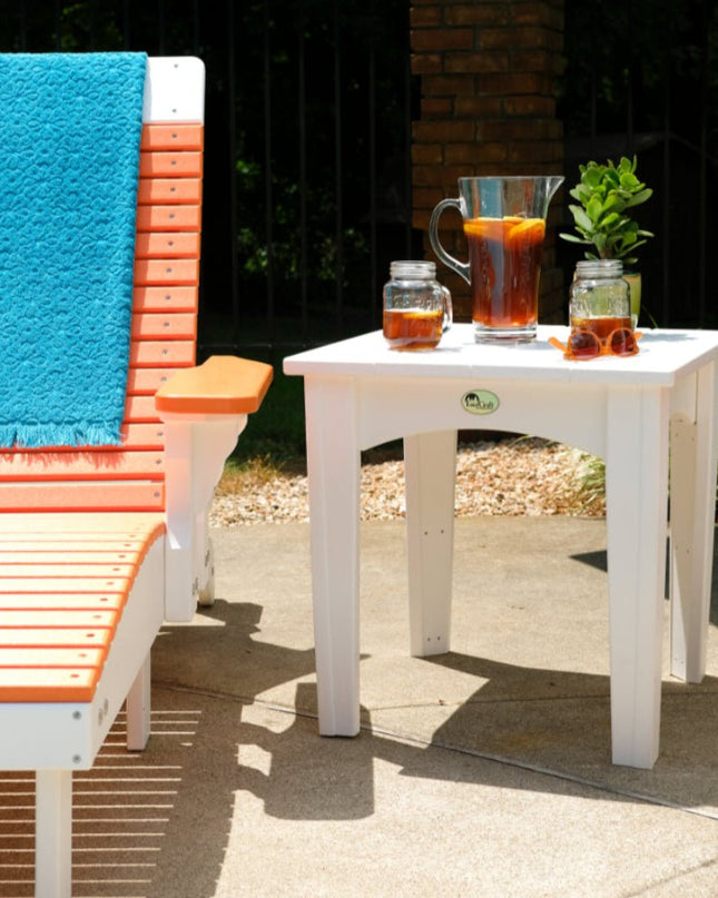 LuxCraft Island End Table featured in white alongside LuxCraft Lounge Chair featured ini tangerine and white.