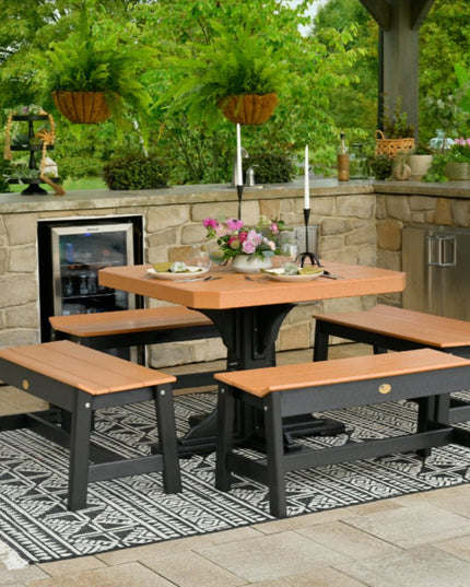 Outdoor polywood patio set with table and benches on a stone patio