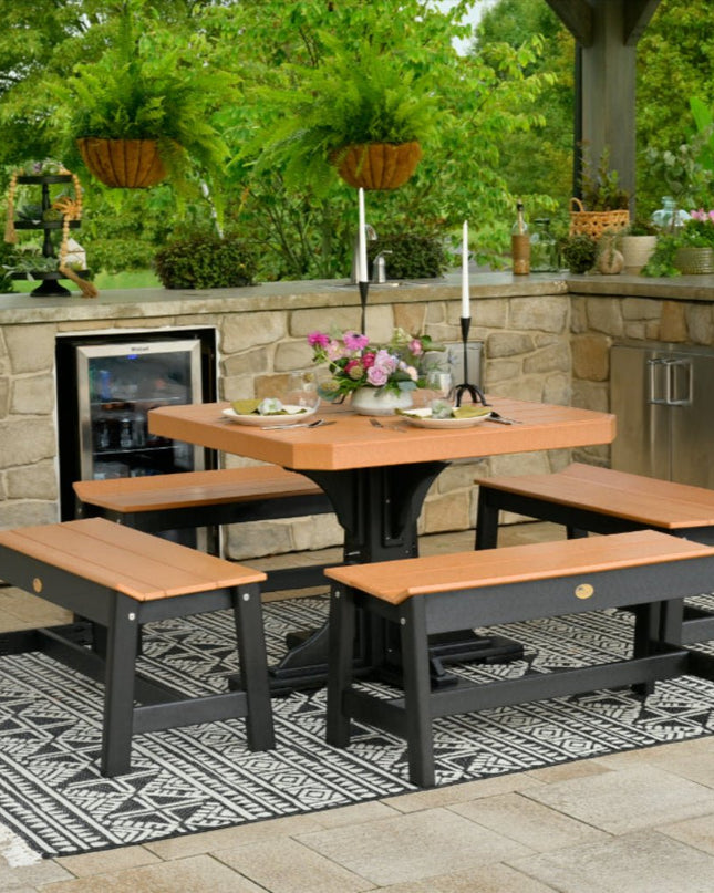 Outdoor polywood patio set with table and benches on a stone patio